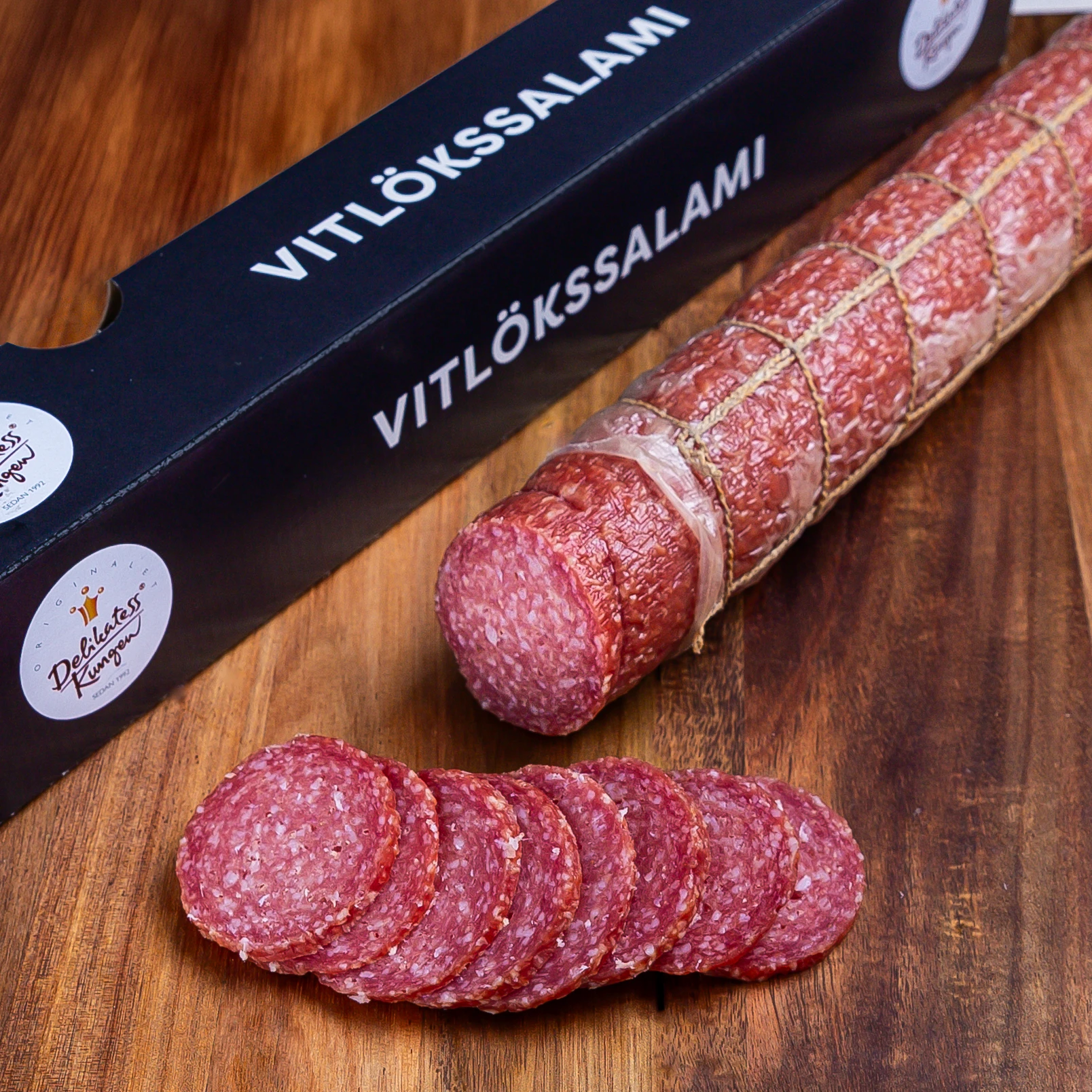 Vitlökssalami från delikatesskungen på skärbräda och låda jämte